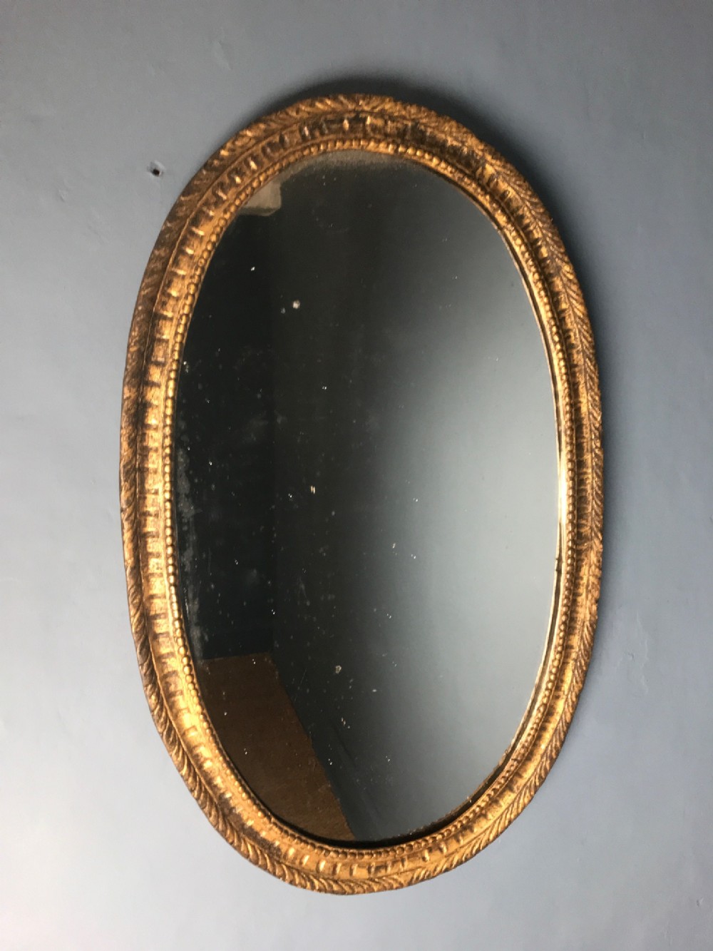 A George 111 gilt elliptical shaped mirror c 1780