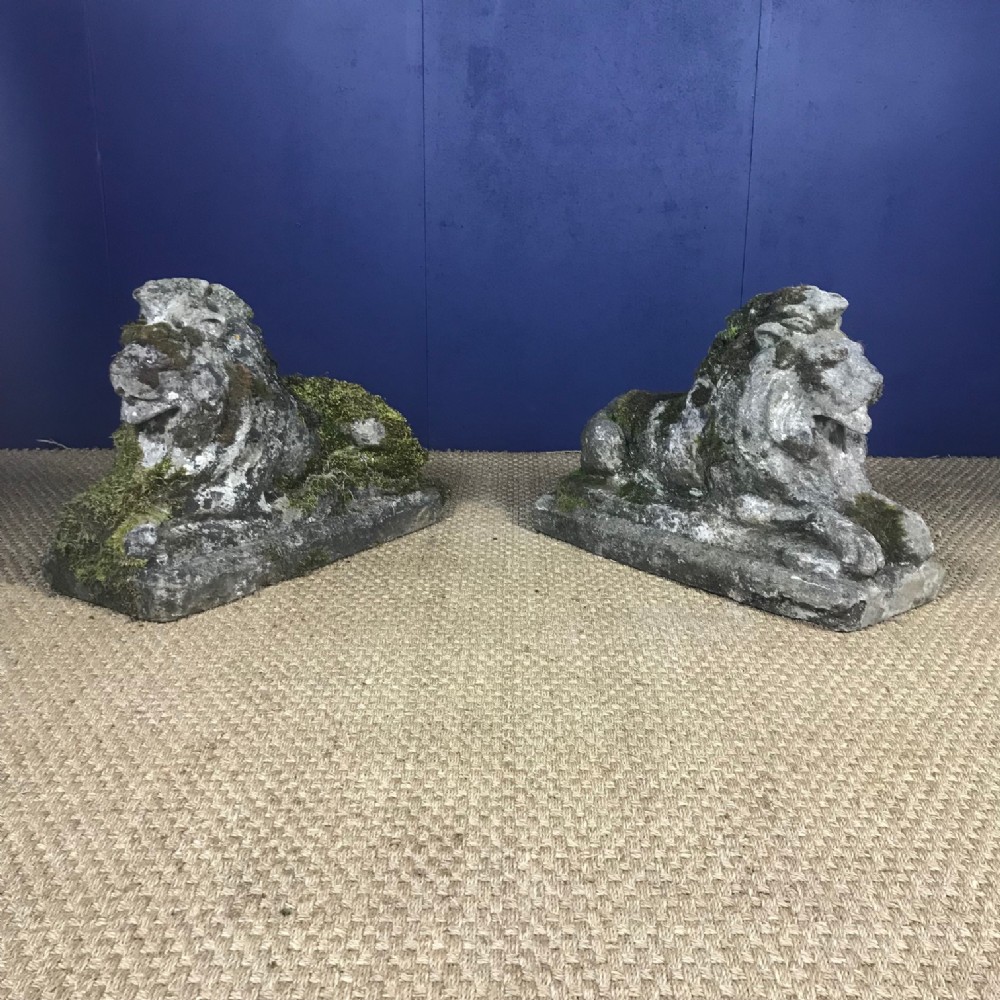 A pair of composite stone seated lions circa 1920