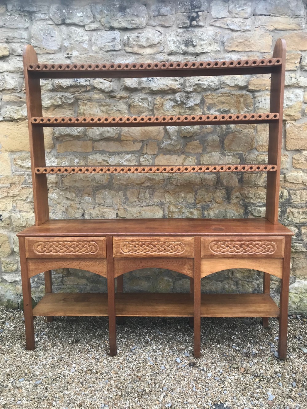 An Arts and Crafts oak dresser in Celtic Style circa 1930