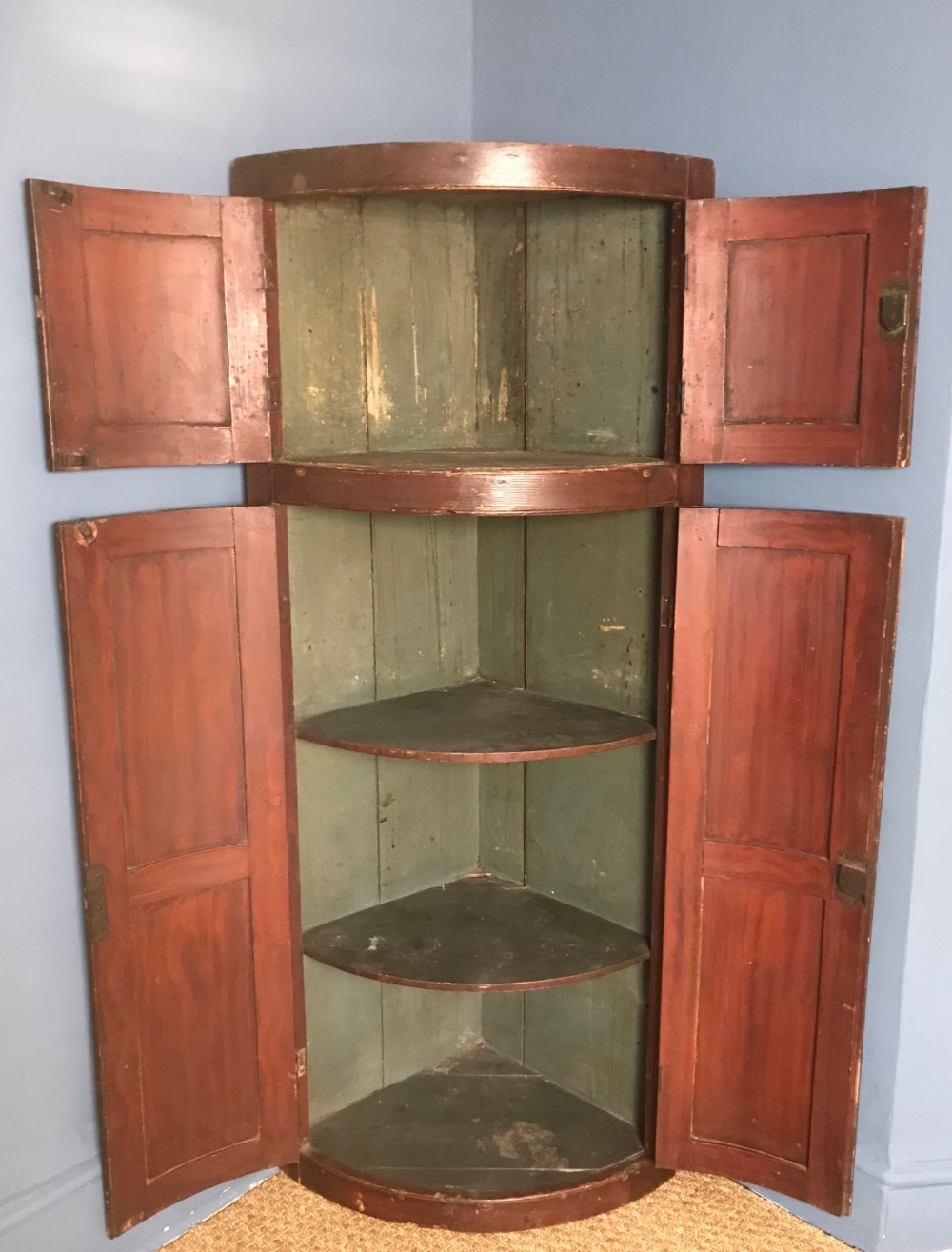 A Georgian painted pine corner cupboard circa 1820