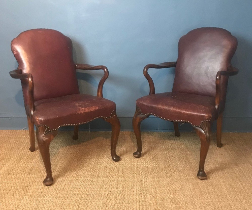 A pair of Maples of London walnut and leather desk chairs circa 1920 