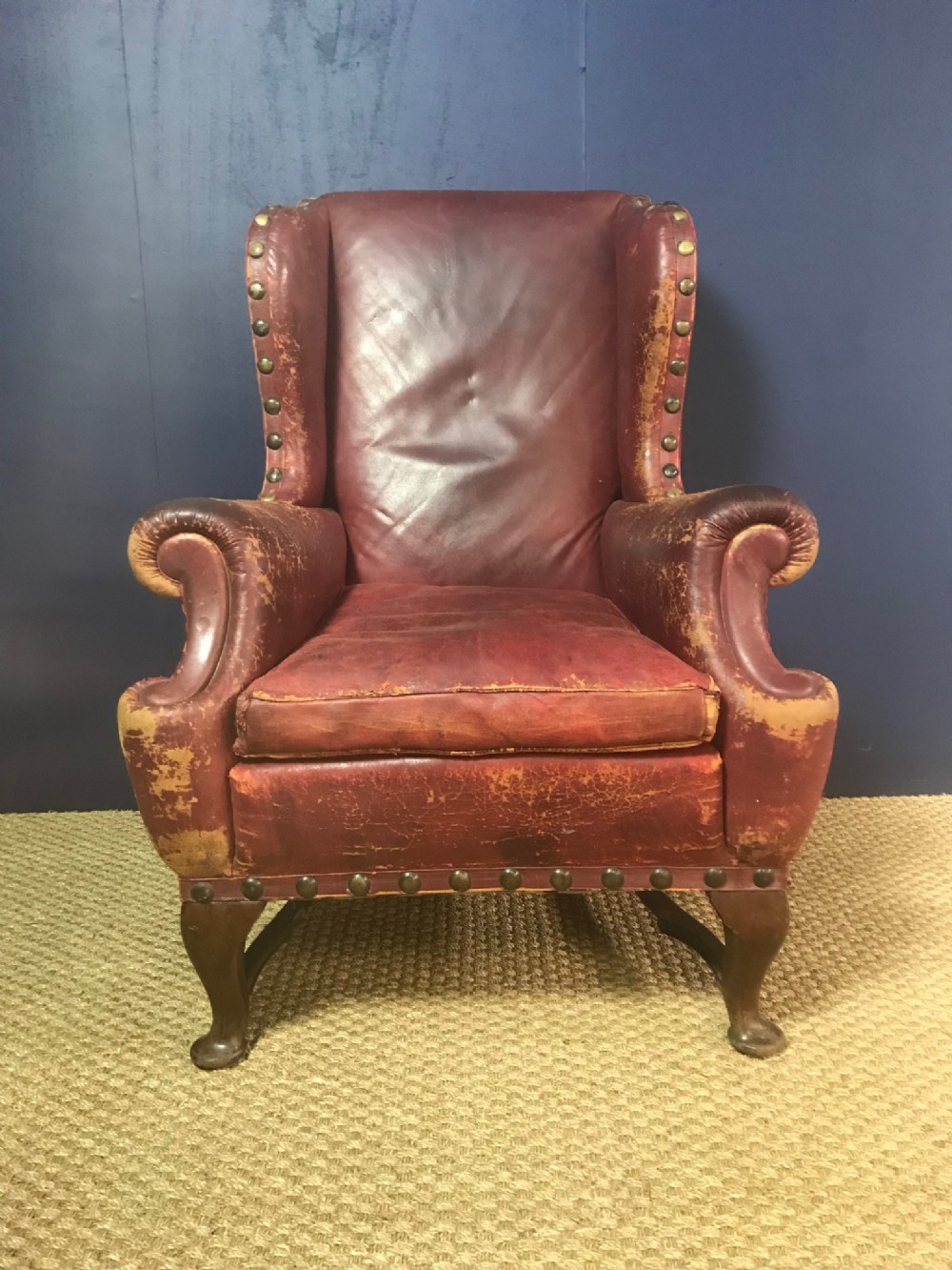A large late Victorian red leather wing armchair circa 1900