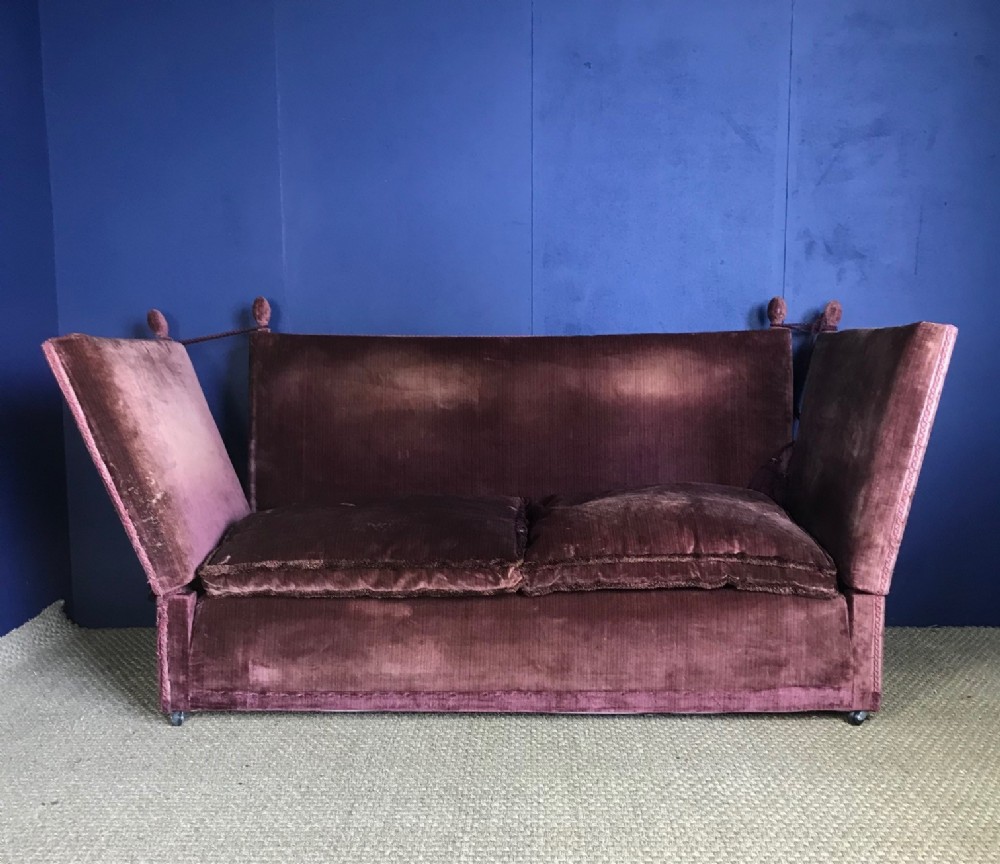A Knole Sofa circa 1920 covered in the  original wine coloured velvet 