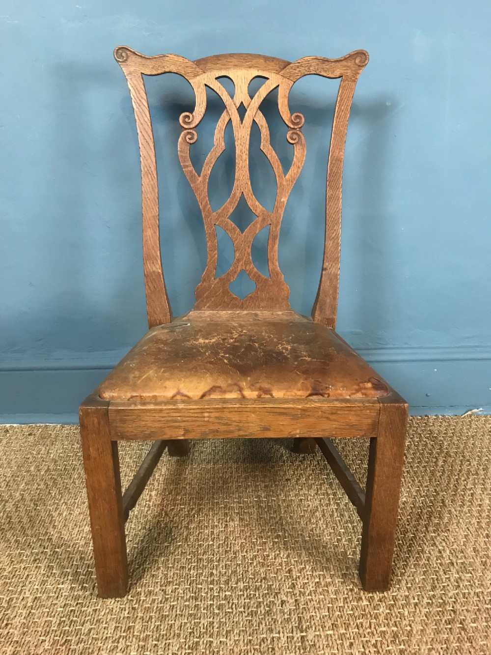 A Scottish oak low chair by Wheeler of Arncroach to a design by Sir Robert Lorimer
