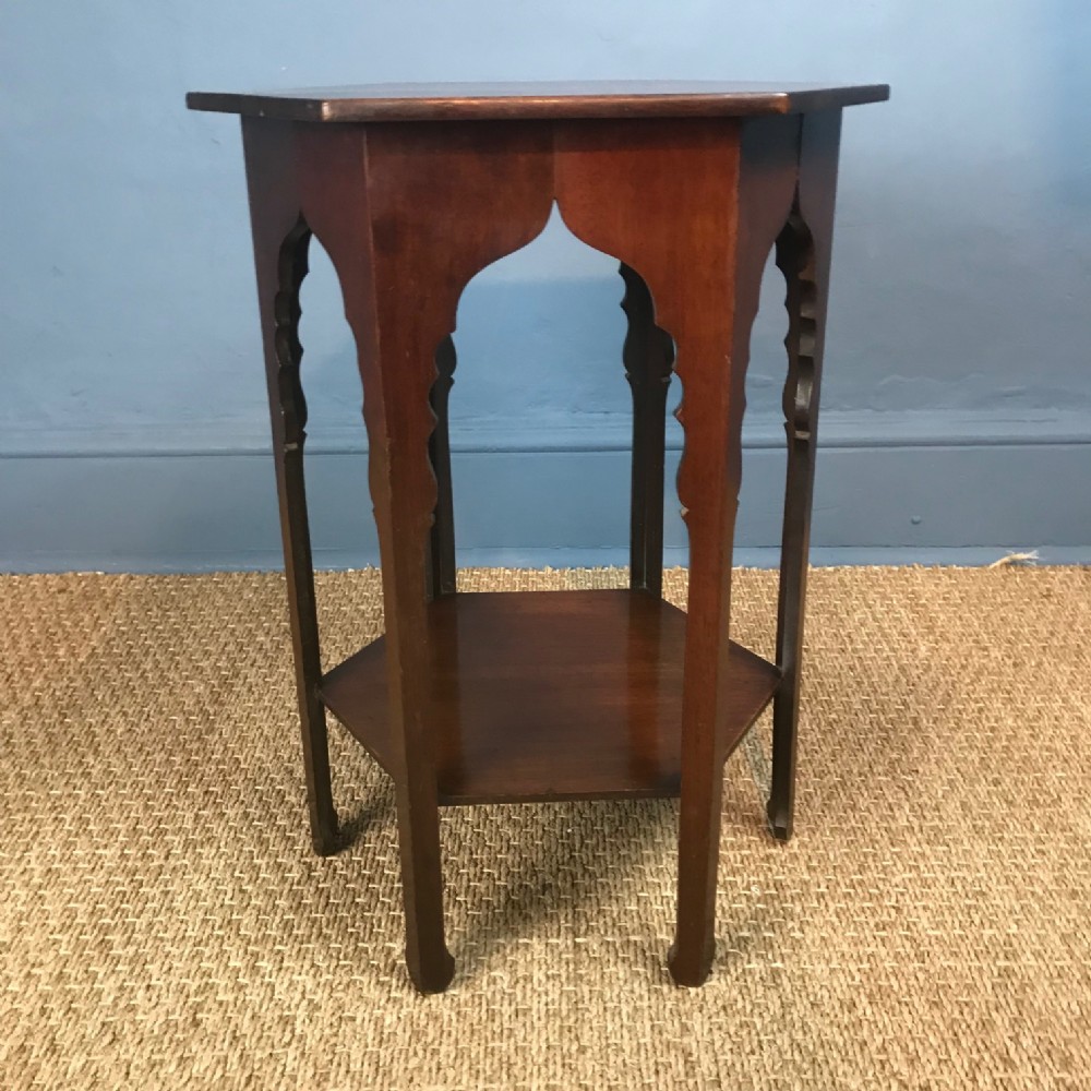 A Liberty and Co mahogany hexagonal table circa 1890 in the Moorish taste .