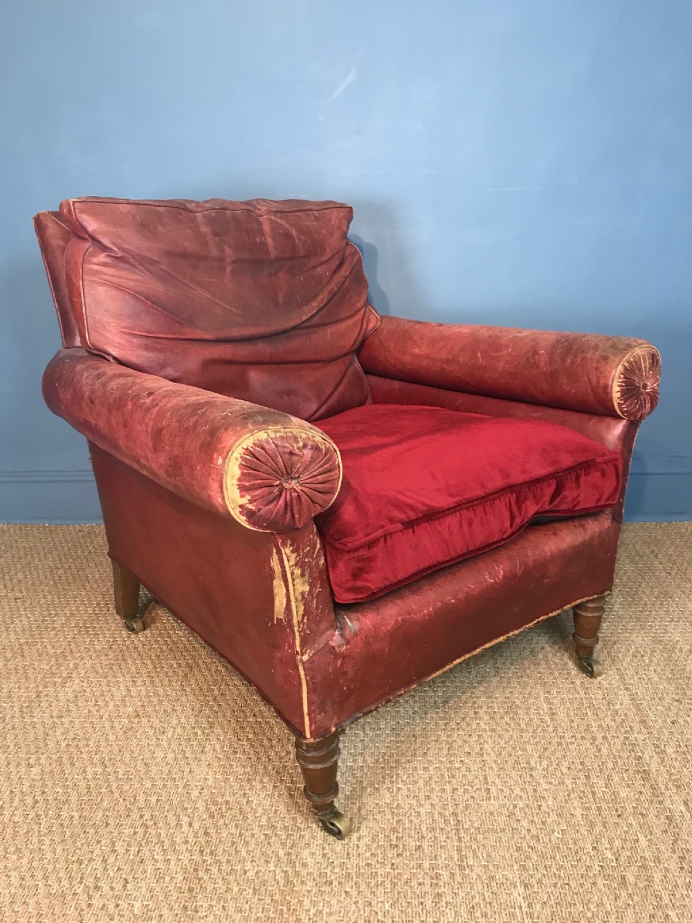 A very large mid 19th c oak library chair in the original red morocco leather