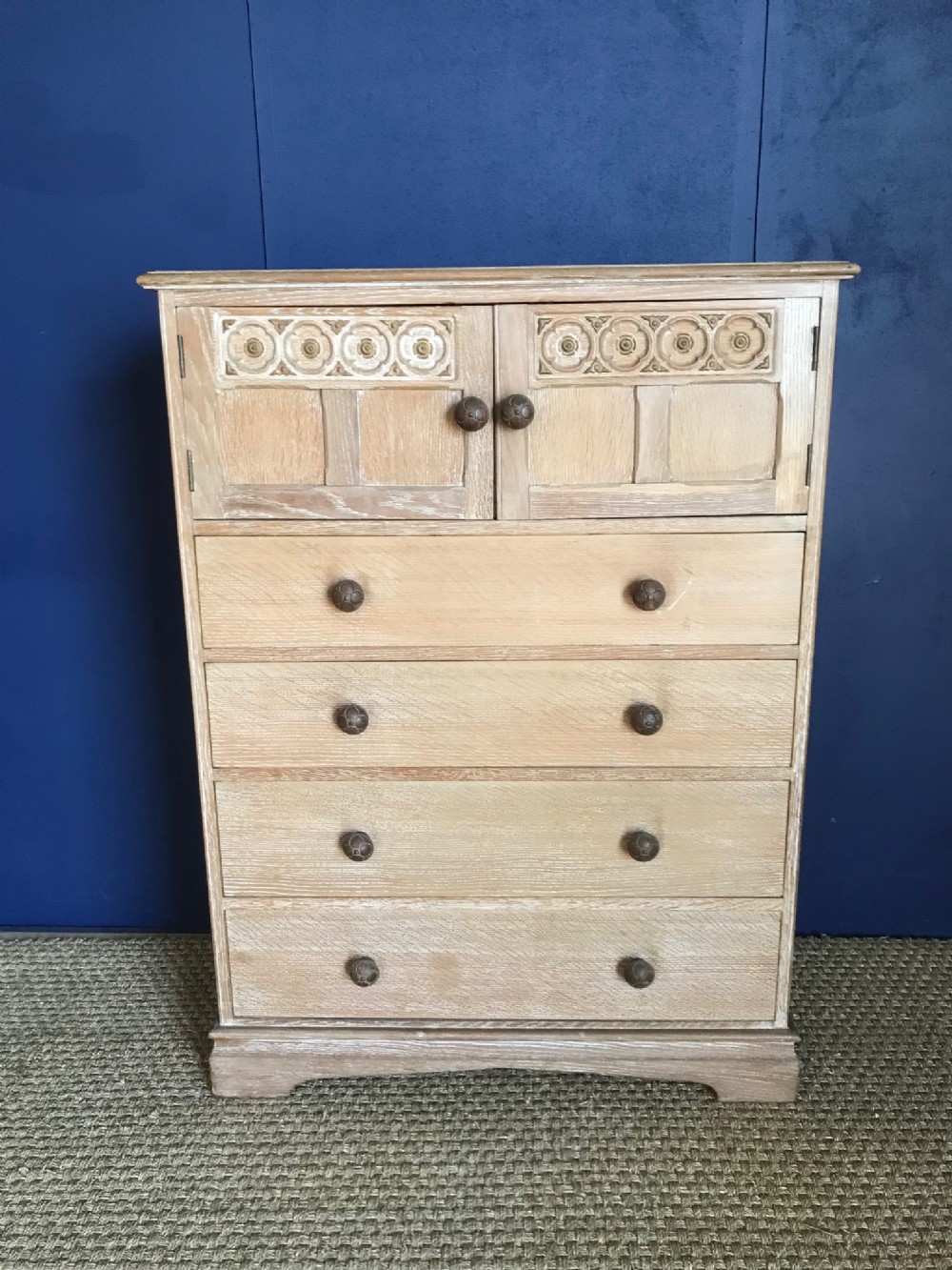 An Arts and Crafts  limed oak tall chest with cupboard circa 1930 