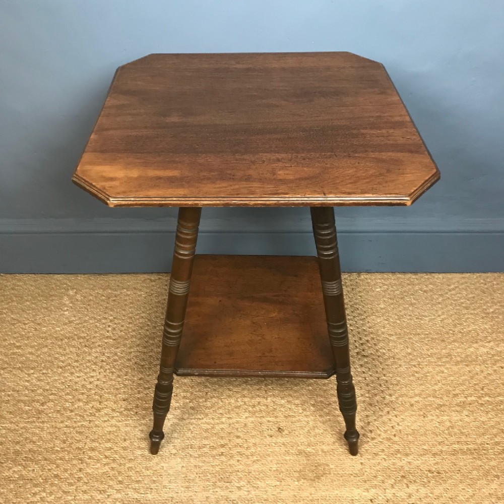An Aesthetic Movement walnut 2 tier table by Schoolbreds circa 1880