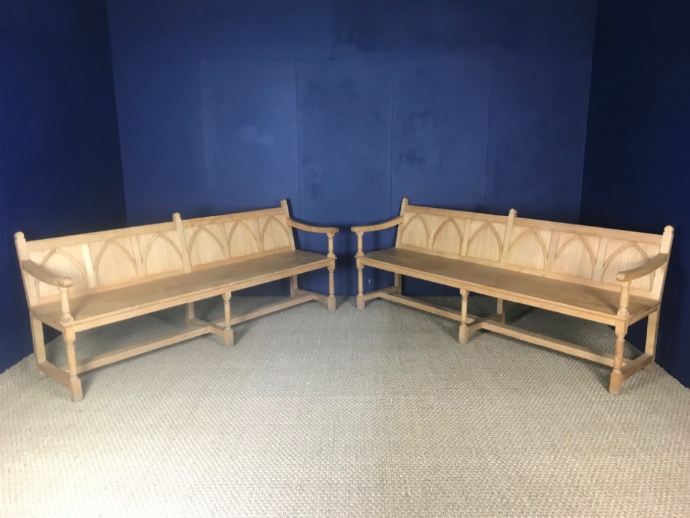 A pair of Arts and Crafts oak hall seats circa 1930 in Gothic style