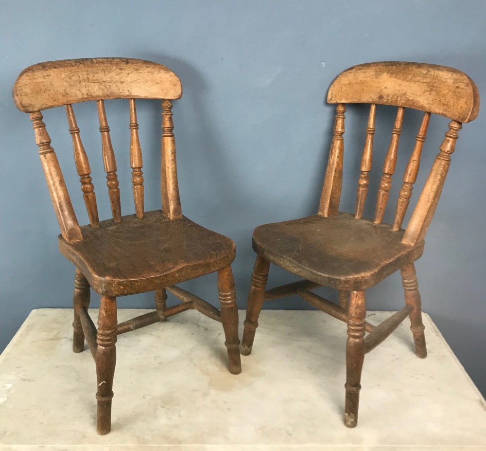 A pair of West Country painted elm childs chairs circa 1880