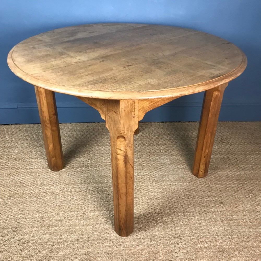 A Cotswold School oak circular table circa 1920  .