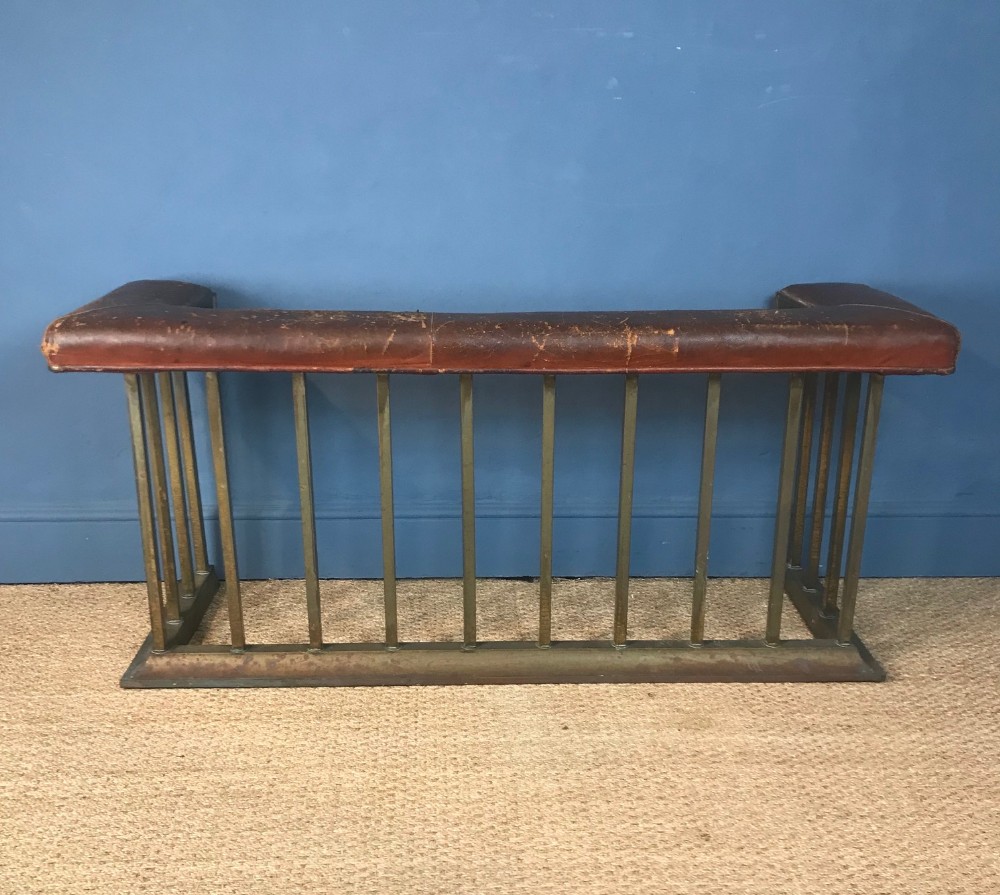 A Victorian brass and leather club fender circa 1910 in totally original condition