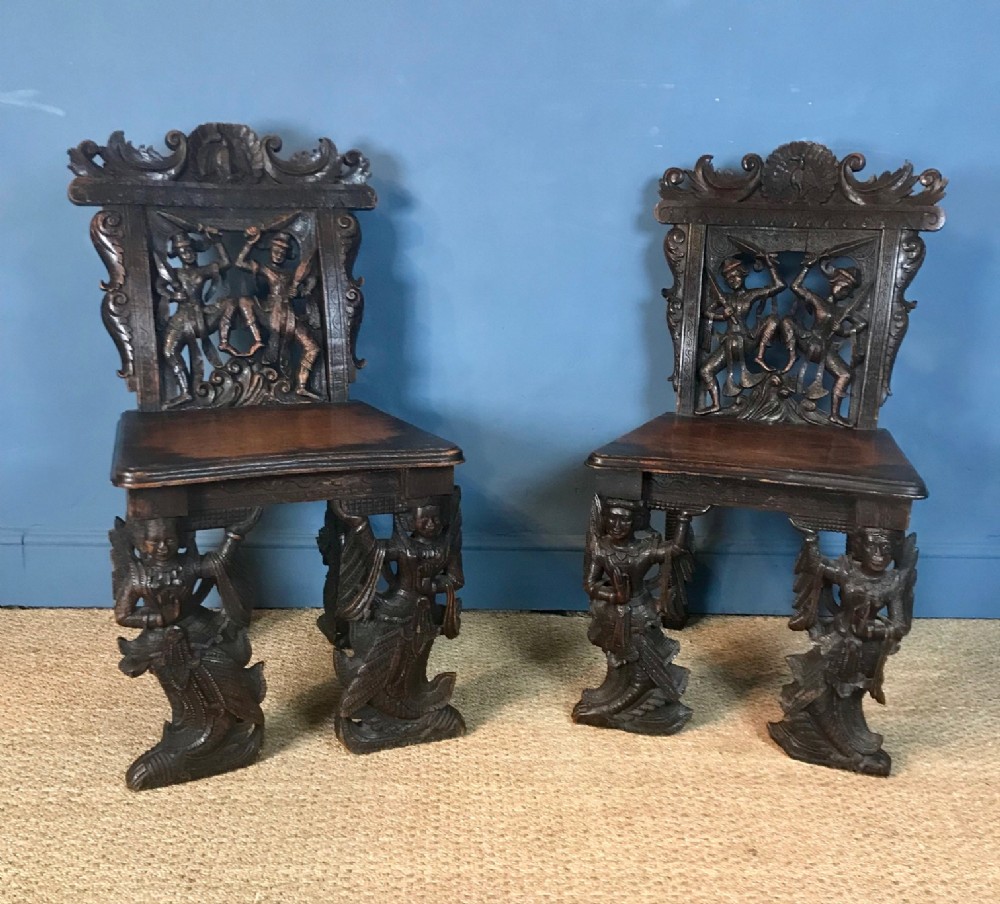 A pair of Burmese carved teak Hall chairs circa 1890