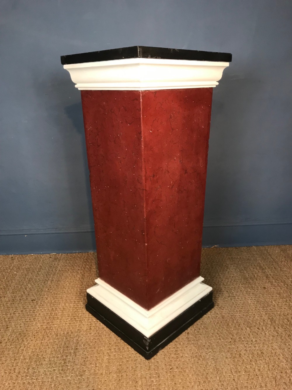 A late Regency simulated porphyry black marble and plaster pedestal circa 1830