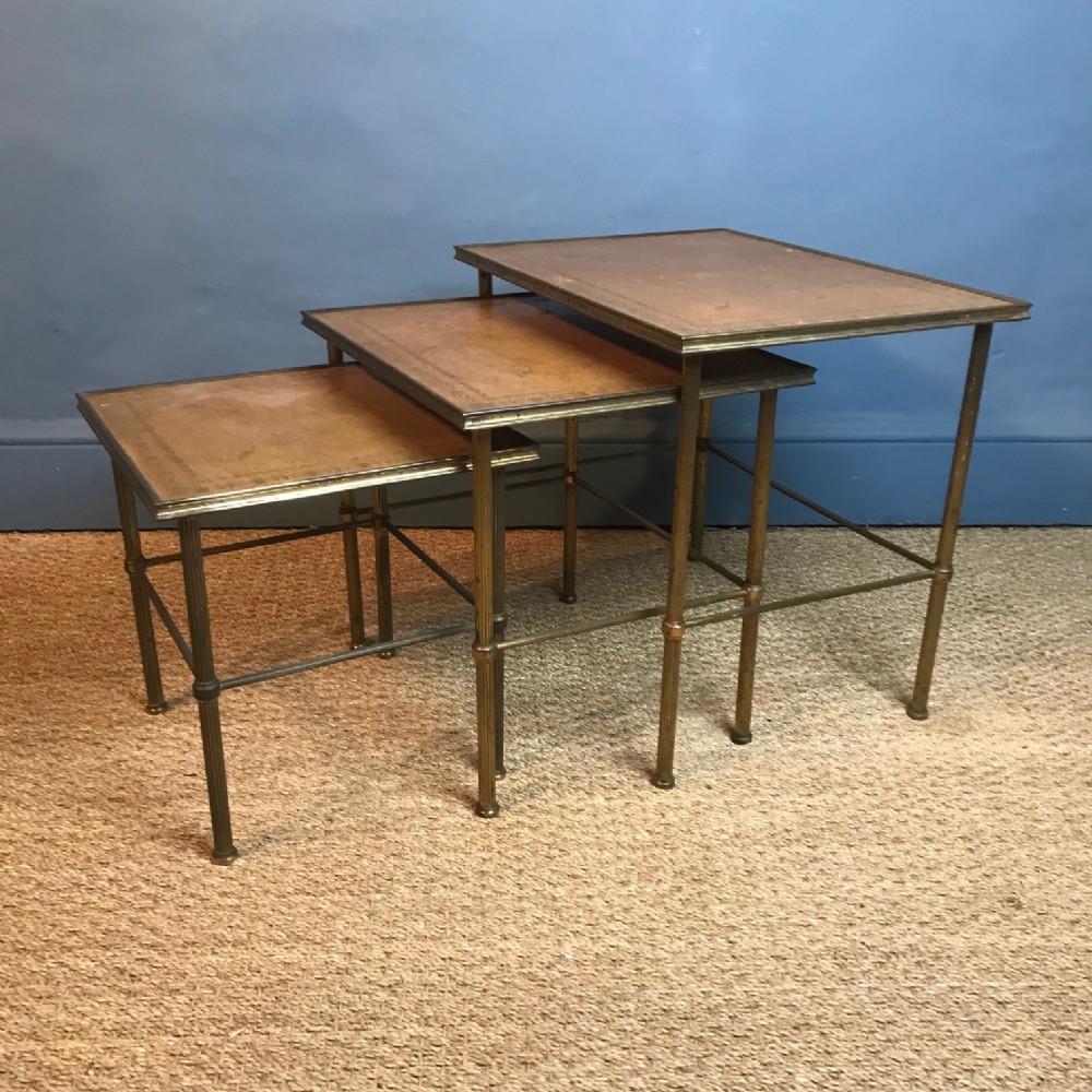A good set of 3 leather and gilt brass tables . English circa 1920