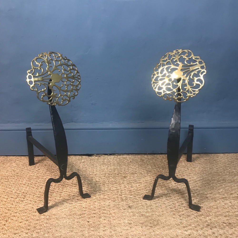 A pair of Arts and Crafts brass and wrought iron fire dogs circa 1910