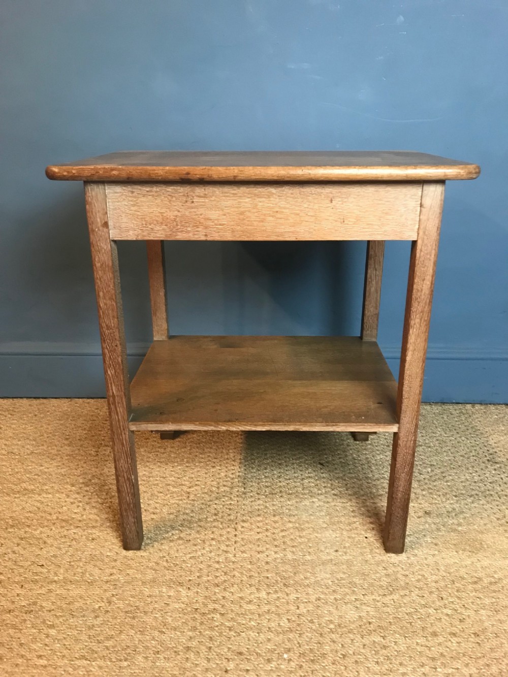 A Waring and Gillows limed oak 2 tier table circa 1920 