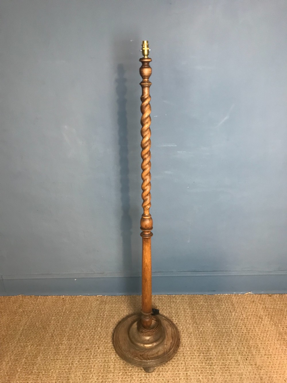 A 1920s oak barley twist standard lamp in the style of Heals