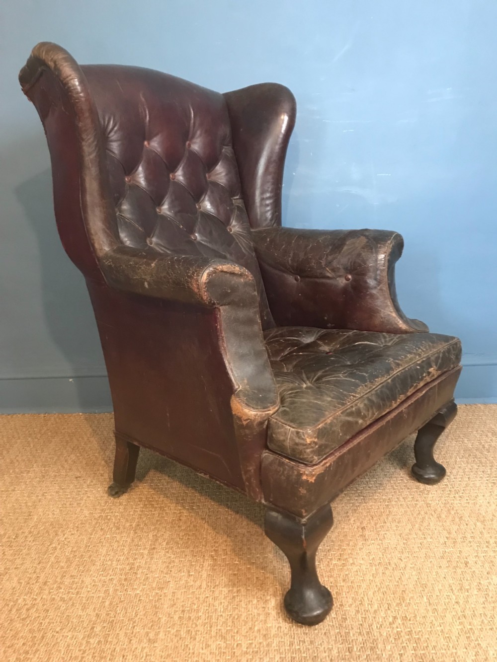 A late Victorian leather wing armchair c 1890 with the original burgundy leather 
