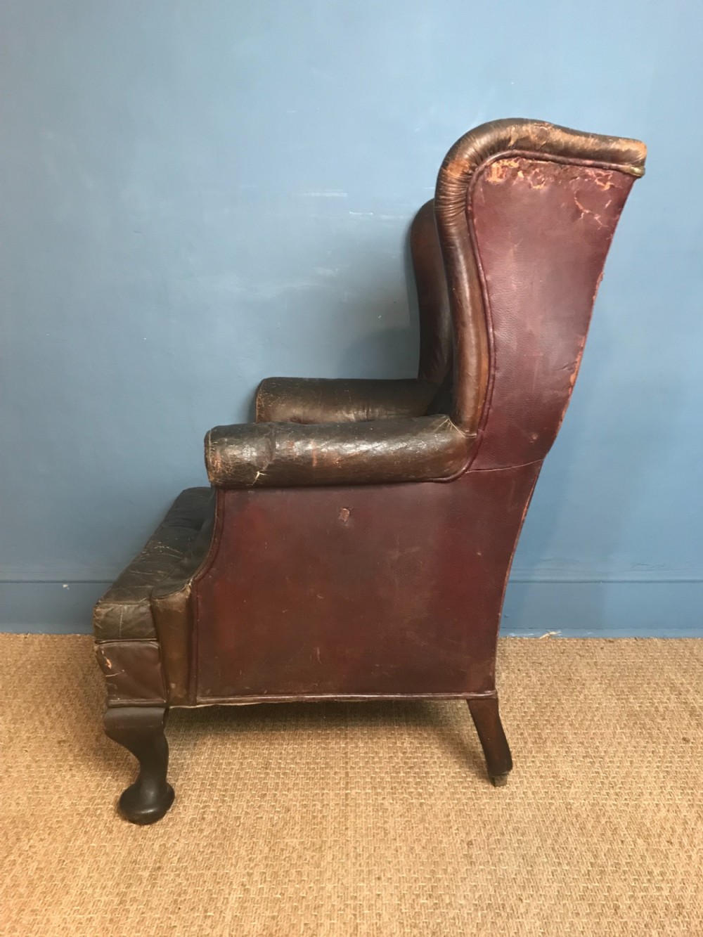 A late Victorian leather wing armchair c 1890 with the original burgundy leather  View III