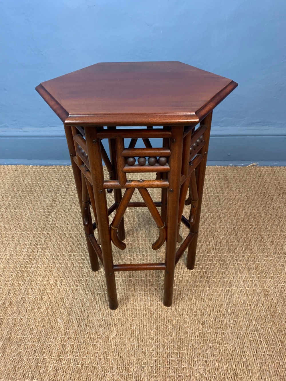 A Liberty mahogany and brass banded small hexagonal table c 1900