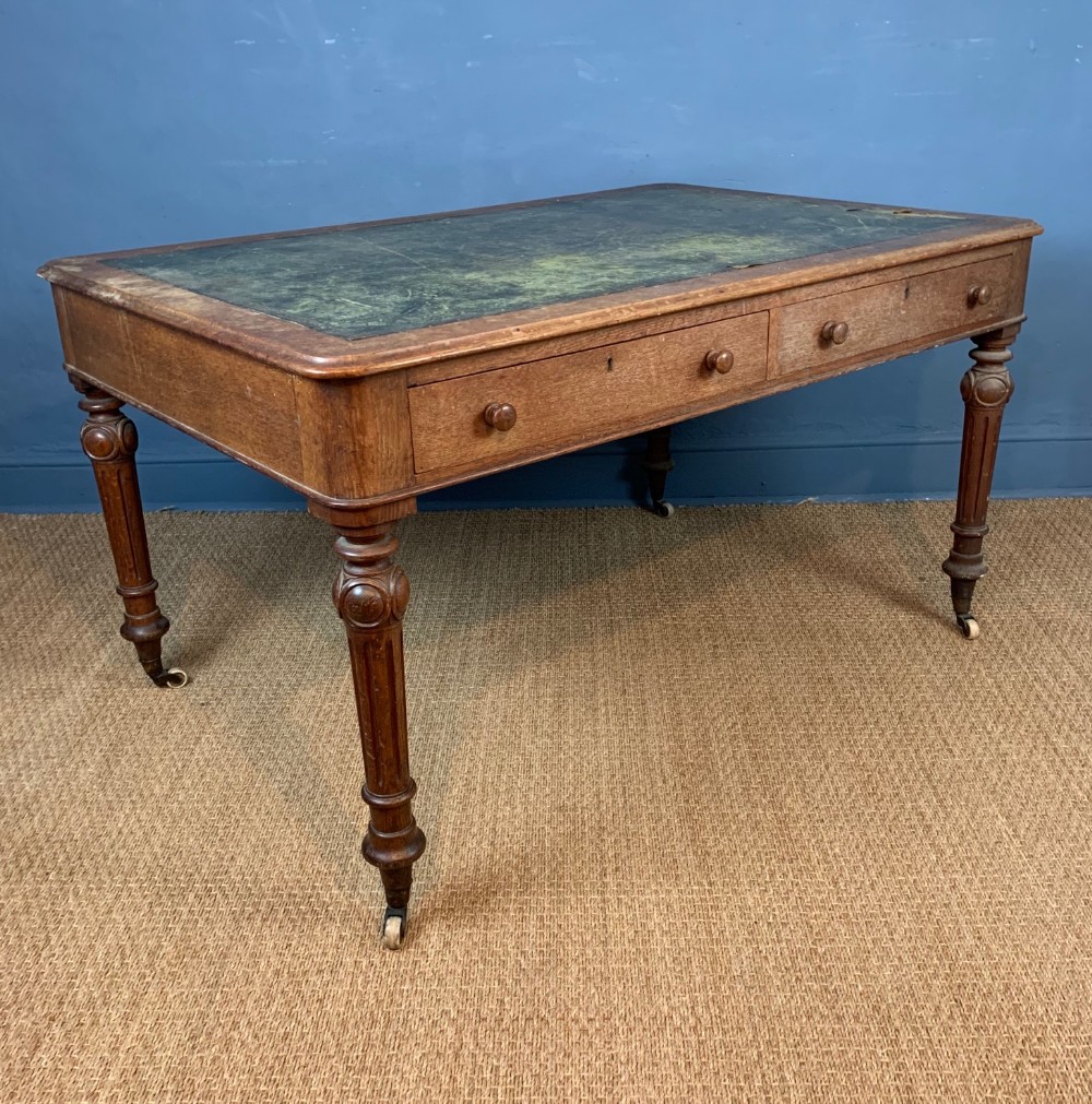 A Victorian oak partners writing table circa 1860
