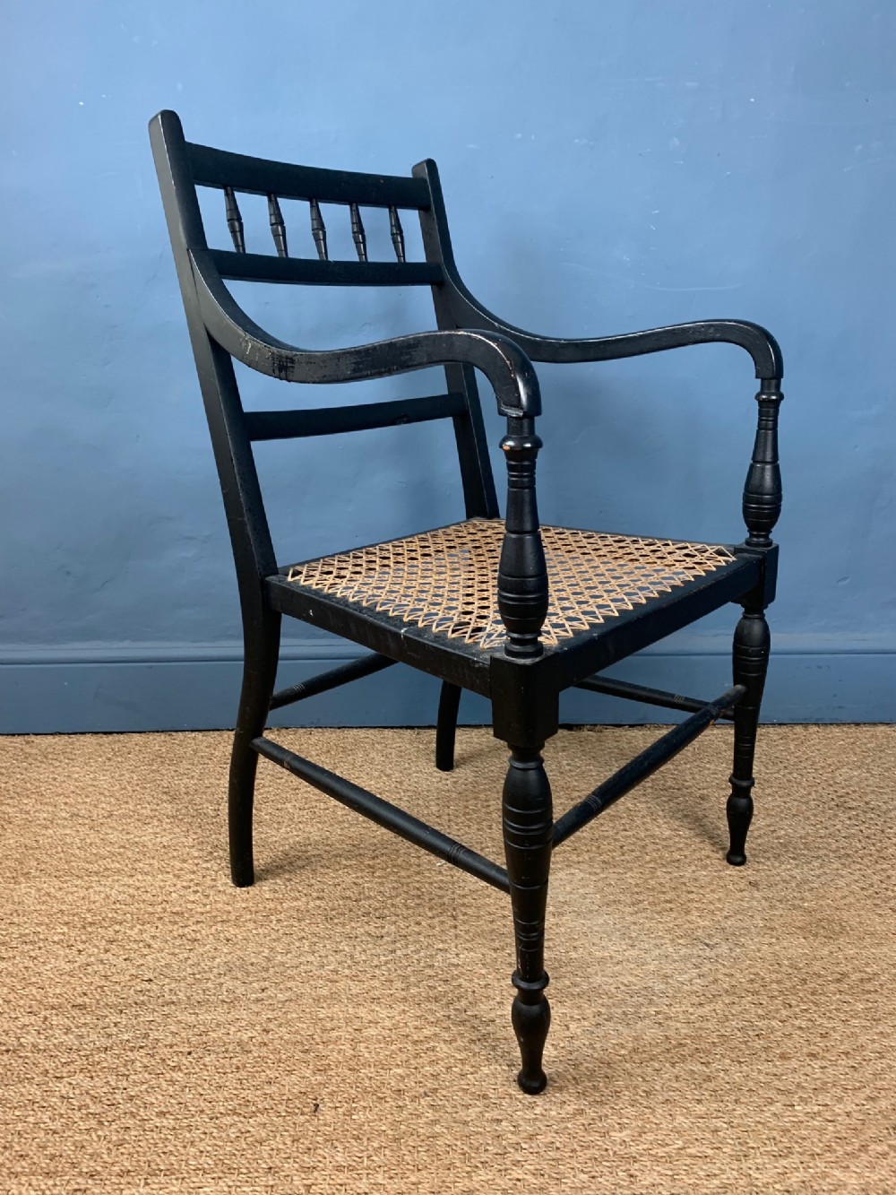 An Aesthetic Movement ebonised and caned arm chair circa 1890