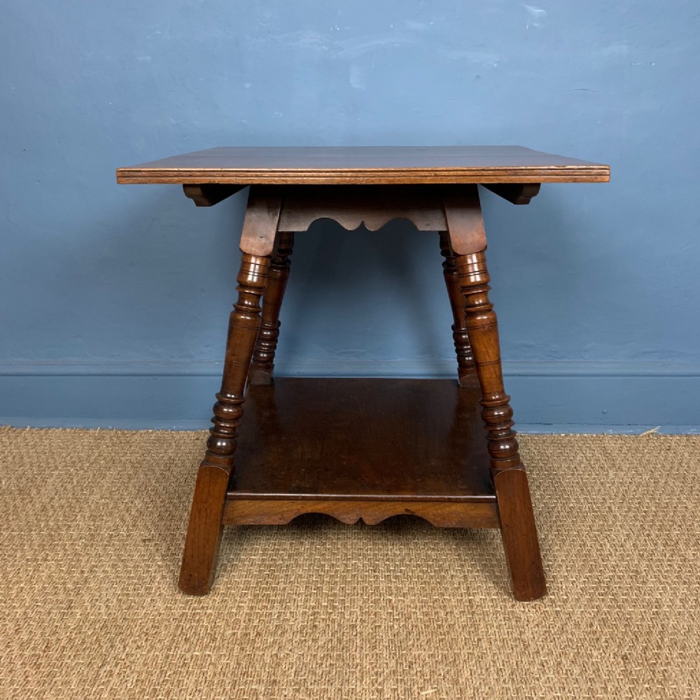 An Aesthetic Movement walnut 2 tier table designed by Charles Eastlake circa 1880 