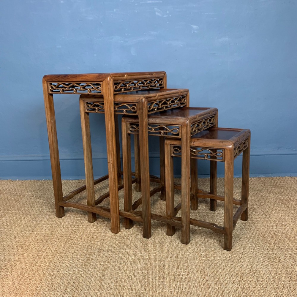 A nest of 4 Chinese Carved Padoukwood tables circa 1890