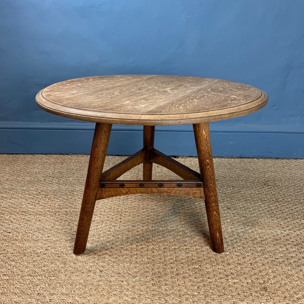 A Cotswold School oak and ebony inlaid low cricket table circa 1925