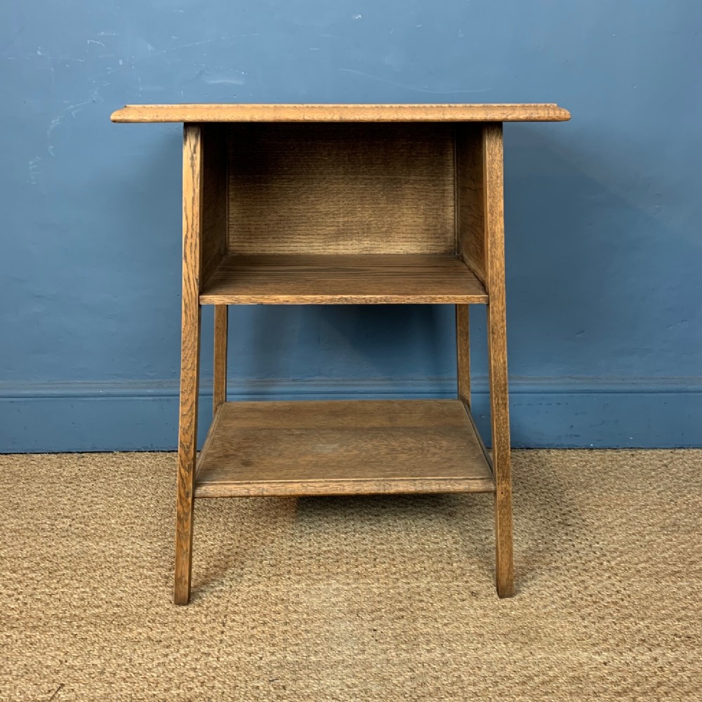 An Arts and Crafts oak two tier book table circa 1910 