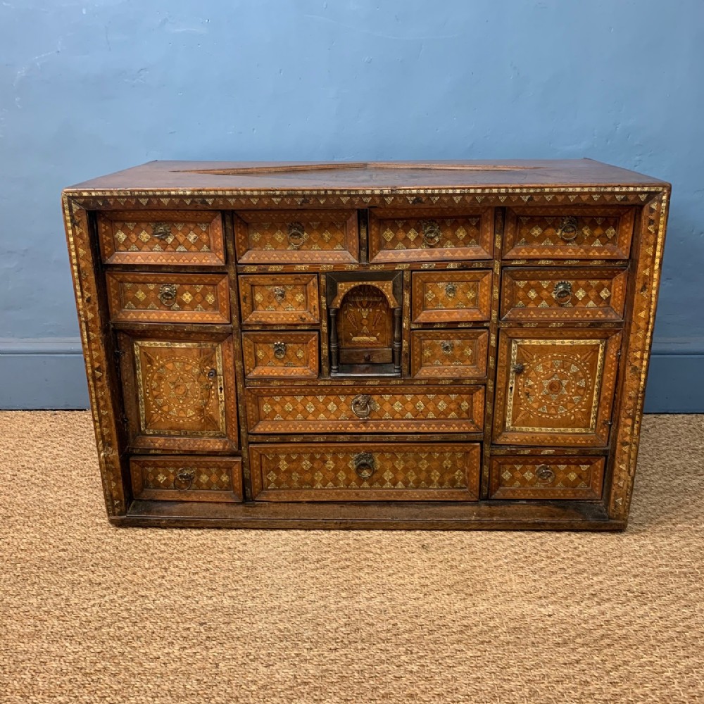 A rare early 17th century Iberian walnut and bone inlaid table cabinet possibly Spanish Colonial dated 1613.