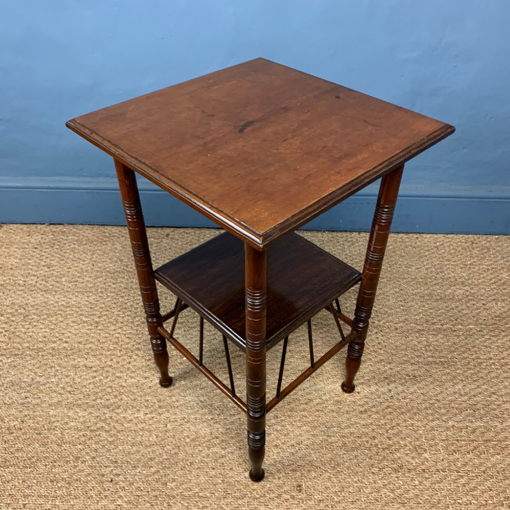 An Aesthetic Movement  walnut two-tiered table c 1880 after a design by EW Godwin.