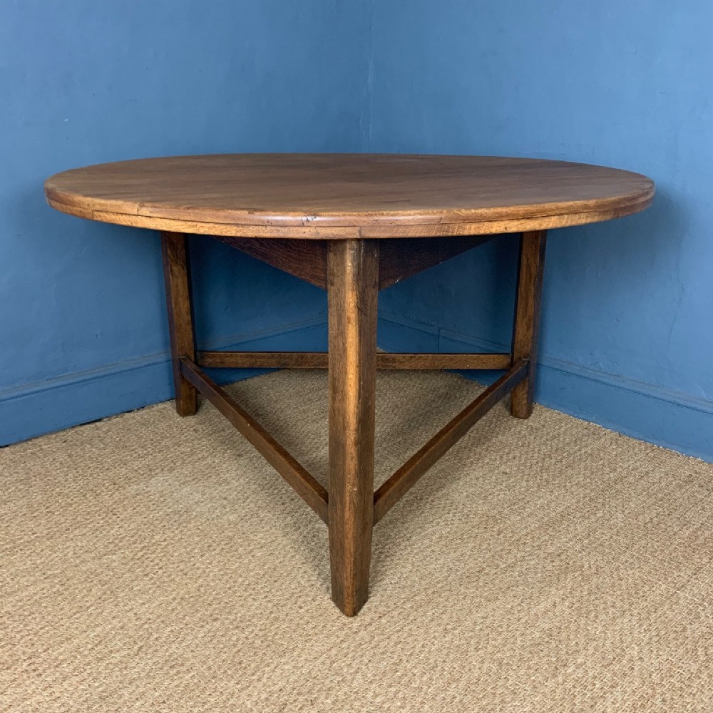 A large Heals oak circular cricket table circa 1910