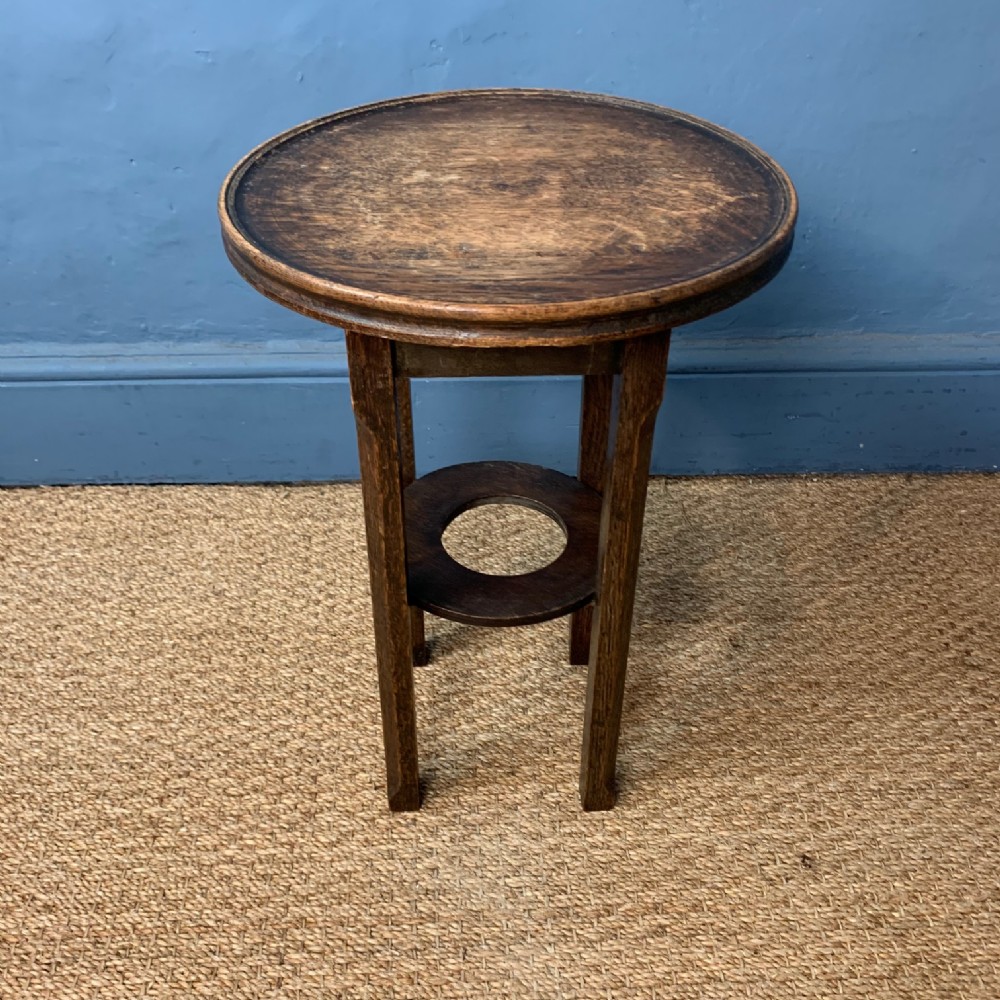 A small Arts and Crafts fumed oak 2 tier table circa 1910.