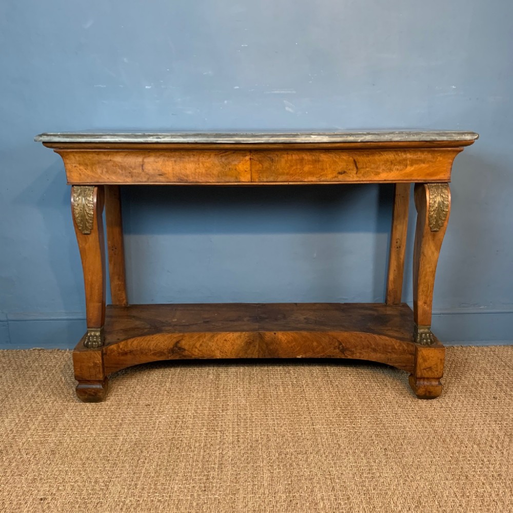 A Charles X walnut and ormolu mounted console table circa 1830