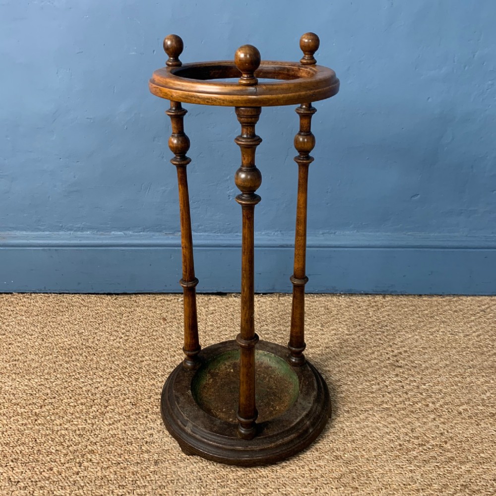 A Victorian walnut and cast iron circular stick stand circa 1890