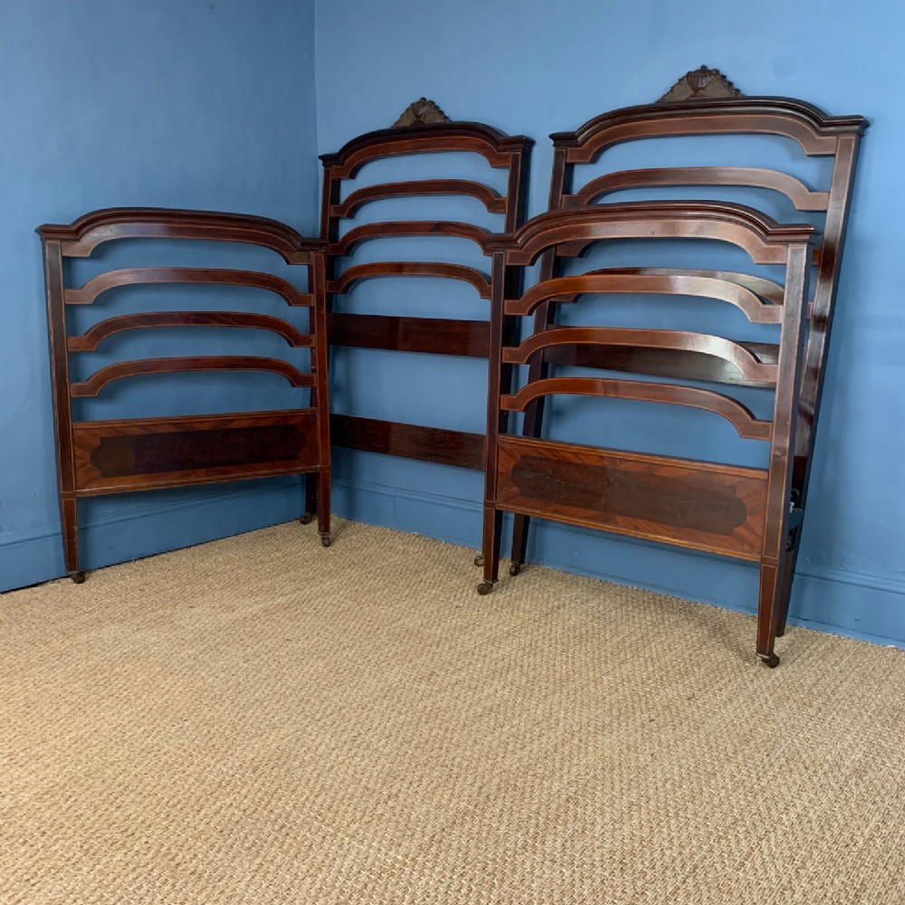 A pair of Edwardian mahogany and boxwood strung single beds circa 1910.