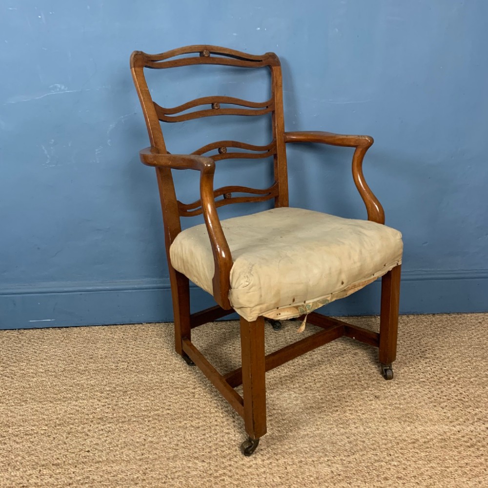 A late 18th century provincial mahogany George 111 ladder back armchair