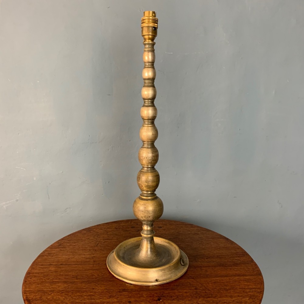 An Edwardian bobbin turned anodised brass table lamp c 1905.