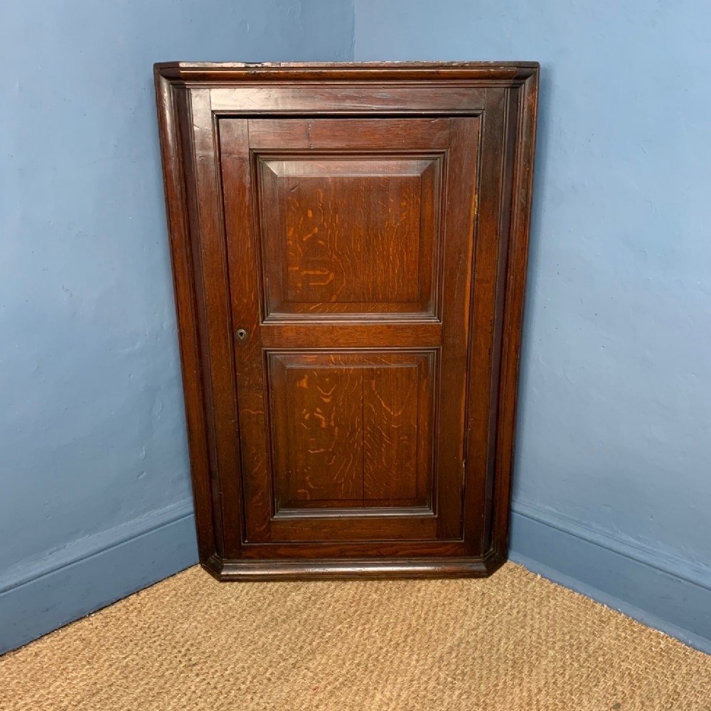 A late Georgian oak West Country Hanging  corner cupboard circa 1820