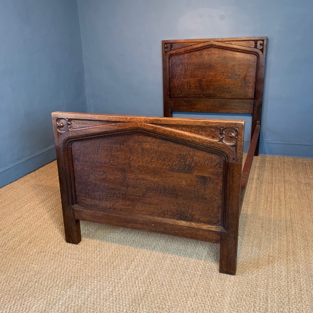 An Edwardian Gothic oak bed circa 1910 
