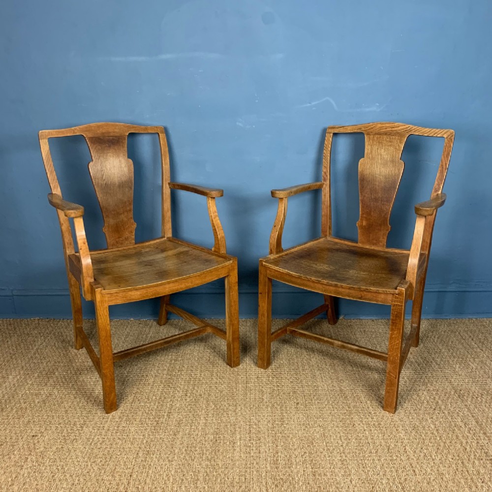 A pair of Heals oak armchairs circa 1930