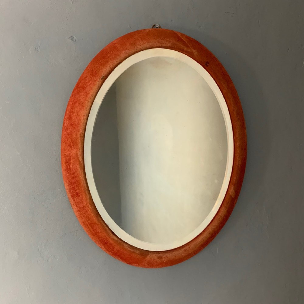 A late Victorian cerise velvet oval mirror c 1890