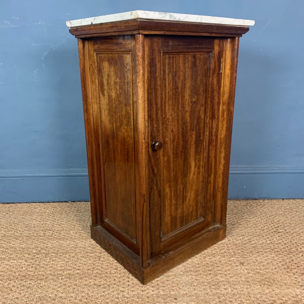 A William IV mahogany and marble top bedside table circa 1830