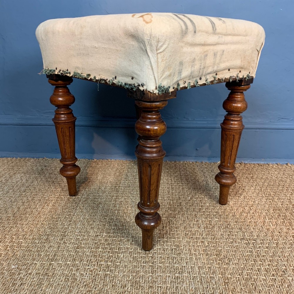 An early Victorian oak stool circa 1850 on turned legs