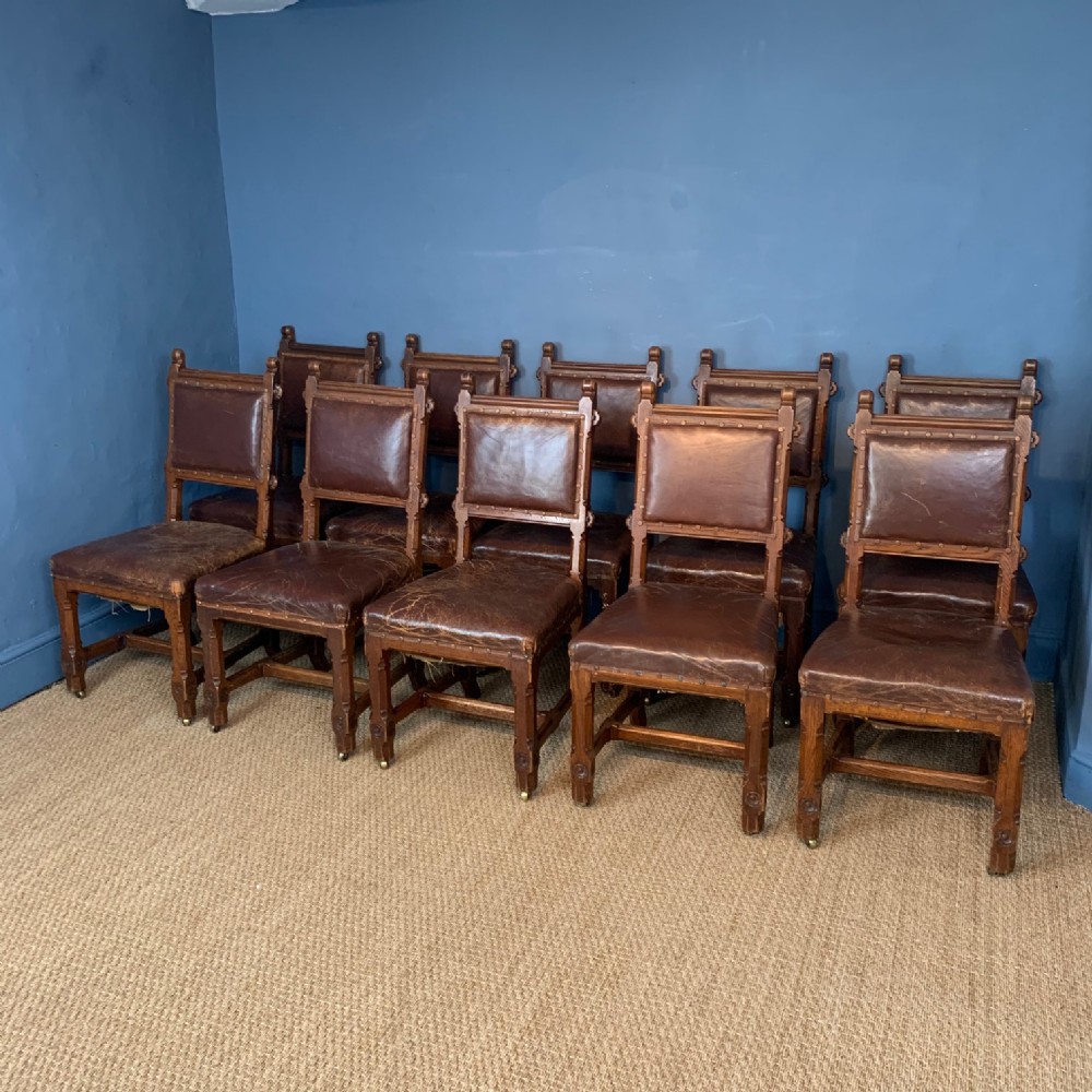 A set of 10 Gothic oak and leather dining chairs circa 1870 to a design by A W N Pugin