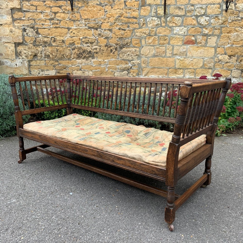 A stylish Arts and Crafts oak bobbin back sofa circa 1890