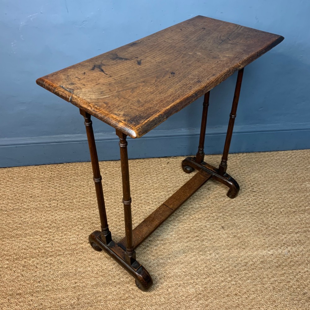 A small George IV elm stretcher table circa 1830 