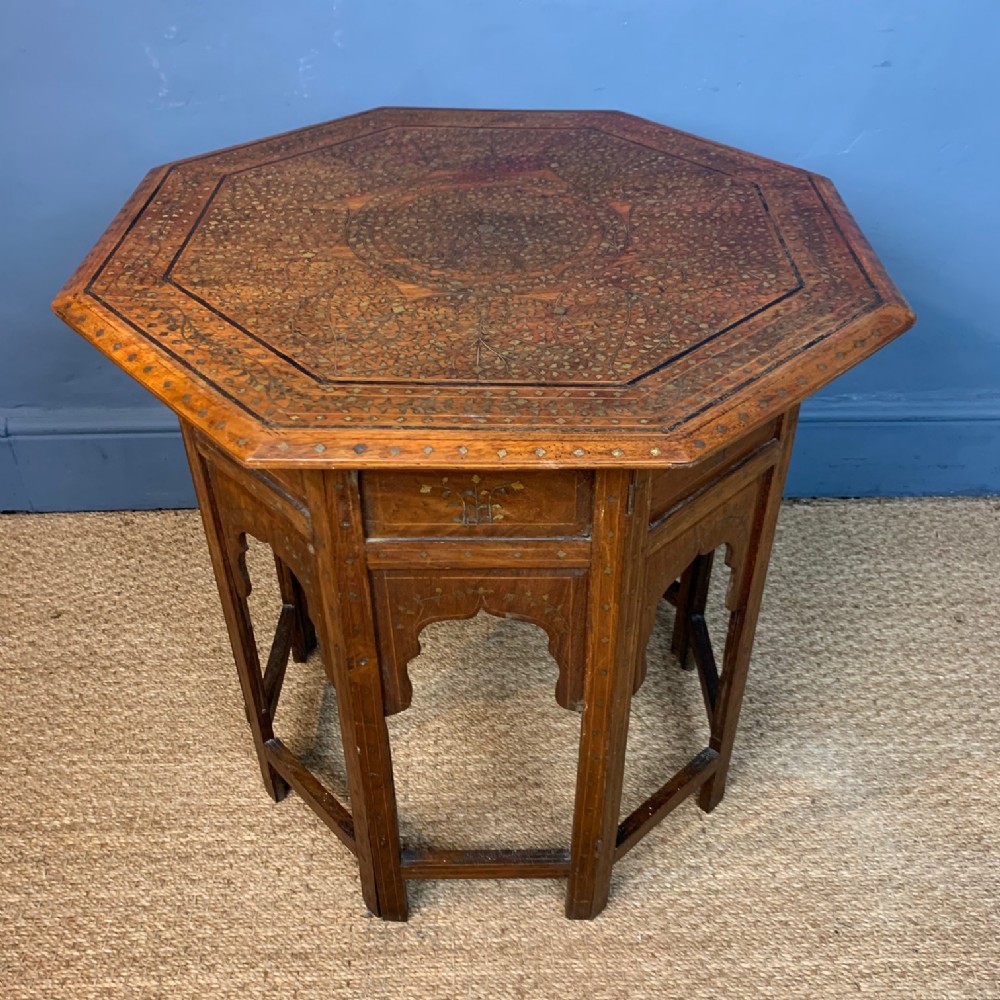A large Hoshiapur octagonal shisham wood brass and ebony inlaid table circa 1900 .